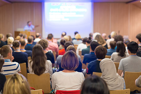 Audience in lecture hall on scientific conference.